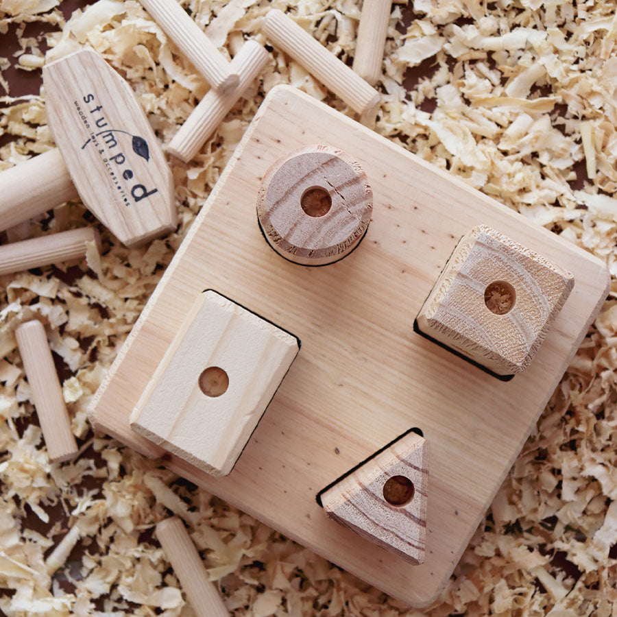 Wooden blocks with holes on a wooden surface