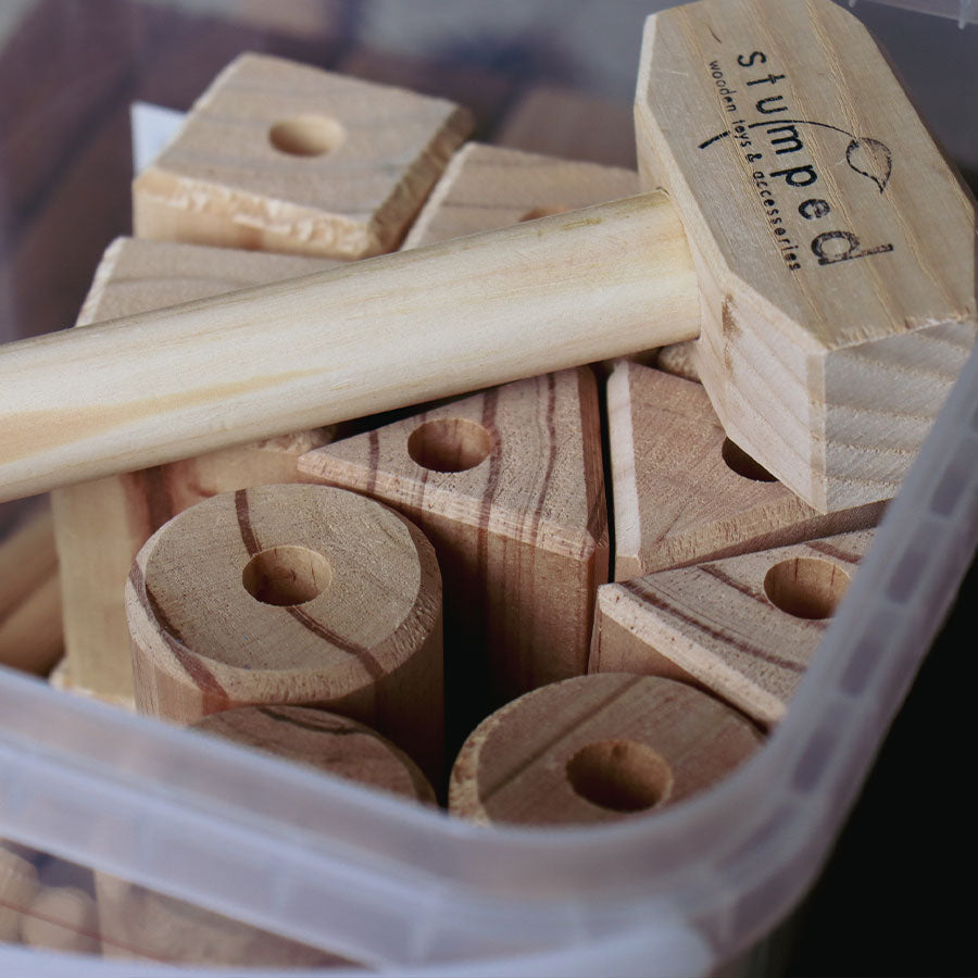 Wooden puzzle pieces with a clear container, featuring the brand 'stumped'.