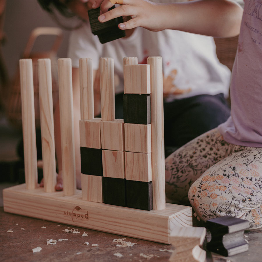 Children playing with wooden blocks on a table