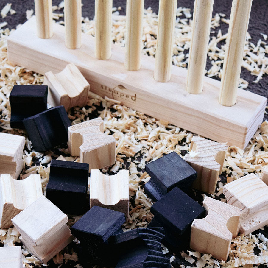 Wooden puzzle game with black, white, and beige pieces on a wooden base