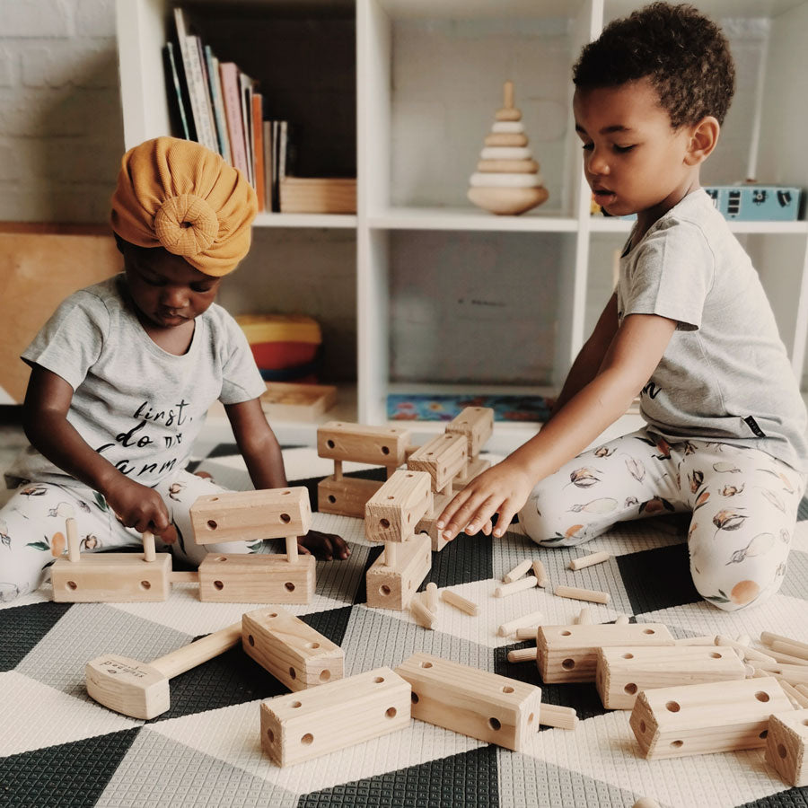 Two children layng with blocks 